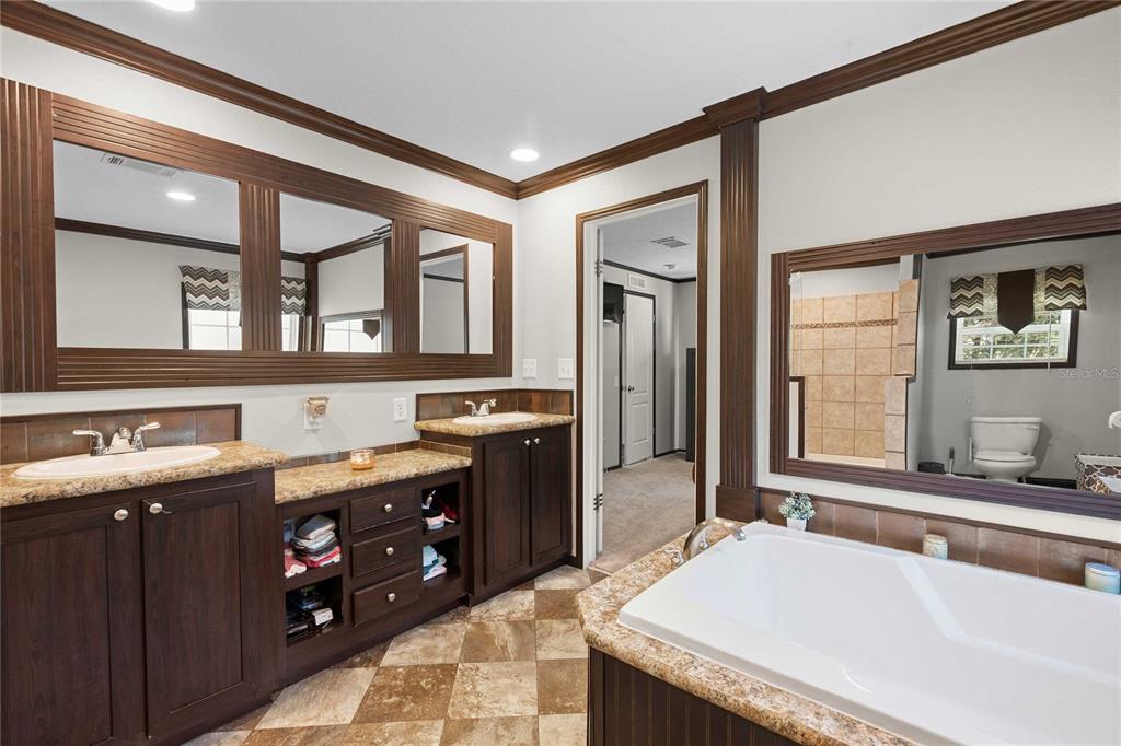 3283 Neff Lake Road Brooksville, FL 34602 - Photo 20 of 37 a spacious bathroom with a granite countertop tub and a sink