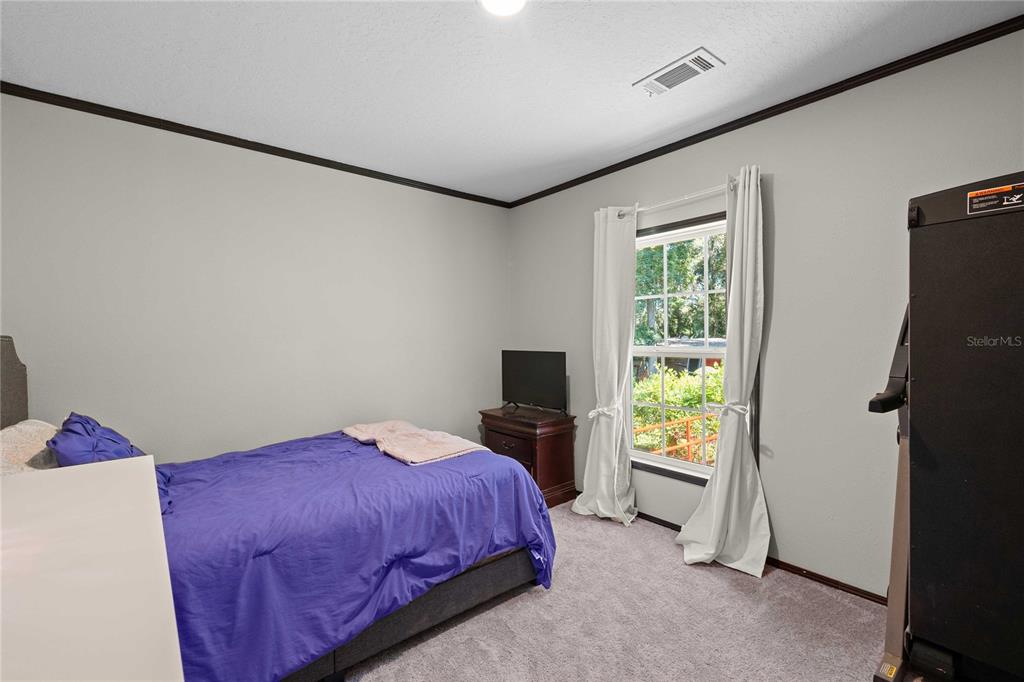 3283 Neff Lake Road Brooksville, FL 34602 - Photo 24 of 37 a bedroom with a bed and a window