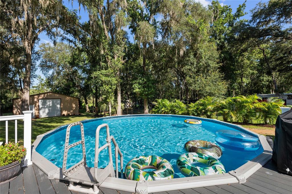 3283 Neff Lake Road Brooksville, FL 34602 - Photo 28 of 37 a view of a chairs and table on the wooden deck