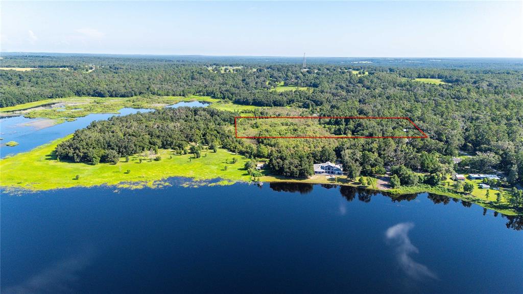 3283 Neff Lake Road Brooksville, FL 34602 - Photo 32 of 37 an aerial view of a house with a swimming pool yard and outdoor seating