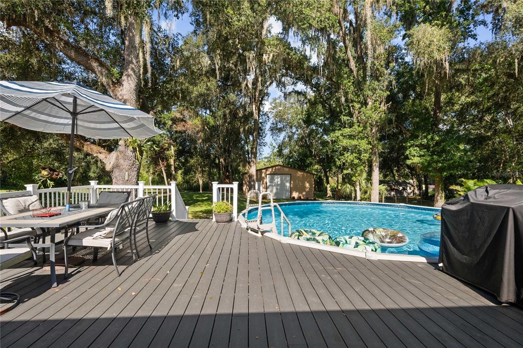 3283 Neff Lake Road Brooksville, FL 34602 - Photo 4 of 37 a view of a wooden deck and a patio