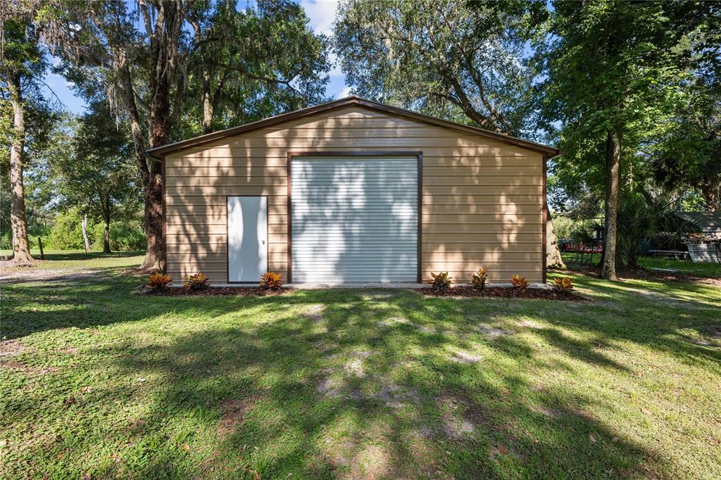 3283 Neff Lake Road Brooksville, FL 34602 - Photo 6 of 37 a front view of a house with a garden