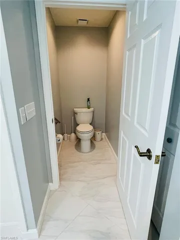 a view of a livingroom with furniture and entryway