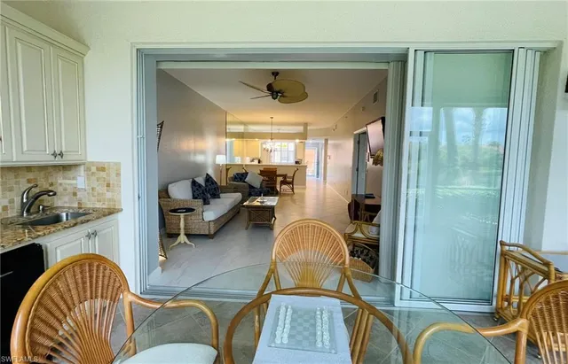 a dining room with furniture a chandelier and a fireplace