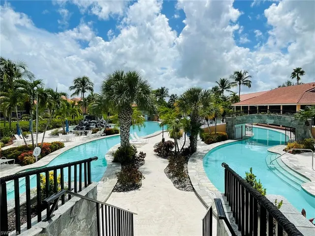 swimming pool view with a seating space