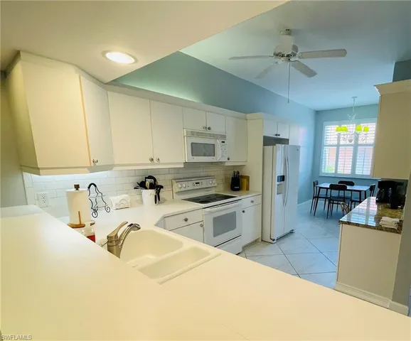 a kitchen with a sink appliances and cabinets