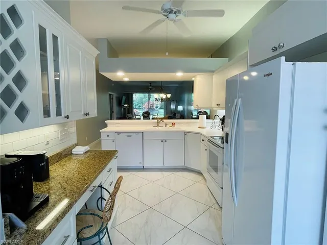 a kitchen with granite countertop a sink and cabinets