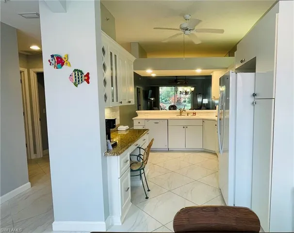 a view of a dining room with a table and chairs