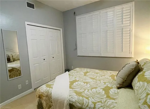 a bedroom with a bed and a ceiling fan