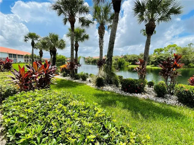 a spacious bedroom with a bed and a chandelier