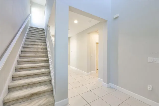 an empty room with a ceiling fan and a window