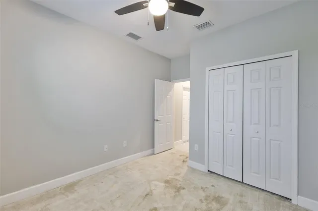 a view of a backyard with wooden fence