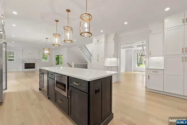 a kitchen with a stove a refrigerator and a fireplace