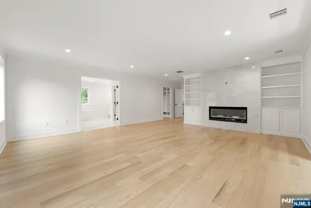 a view of empty room with a fireplace