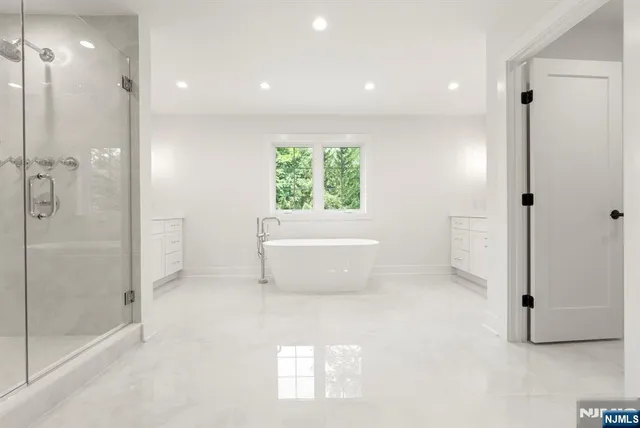 a bathroom with a shower a mirror and a sink