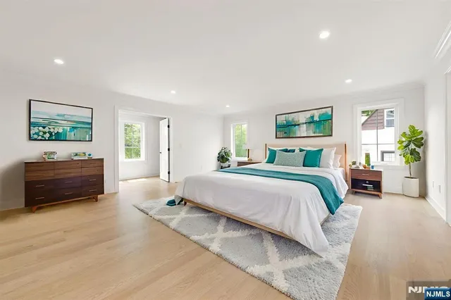 a view of empty room with wooden floor and windows