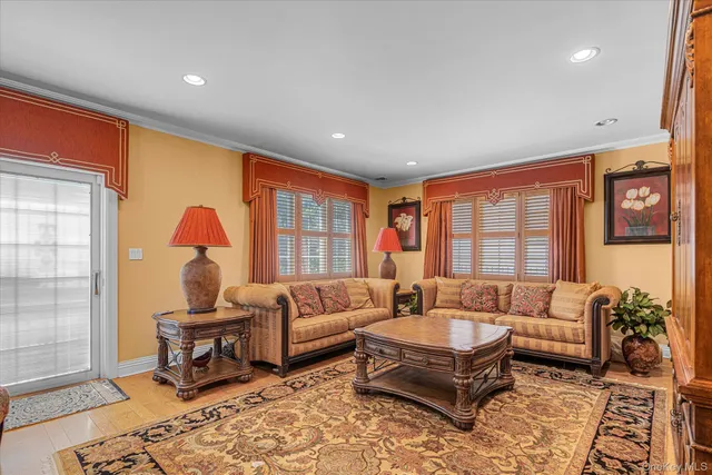 a living room with furniture a rug and a large window