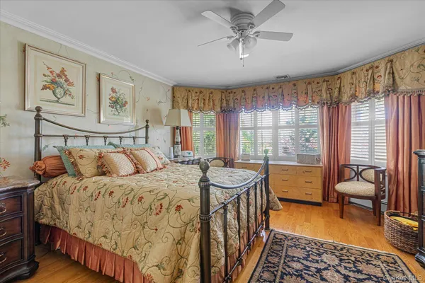a bedroom with furniture and a large window