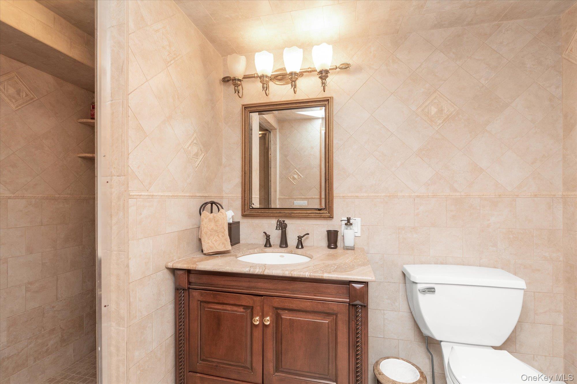 4 Point Crescent Queens, NY 11357 - Photo 19 of 29 a bathroom with a toilet sink and mirror