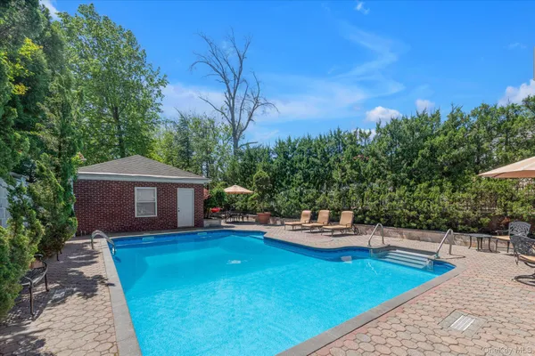 a backyard of a house with table and chairs