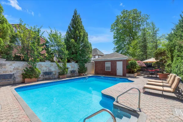 a view of house with backyard entertaining space and seating area