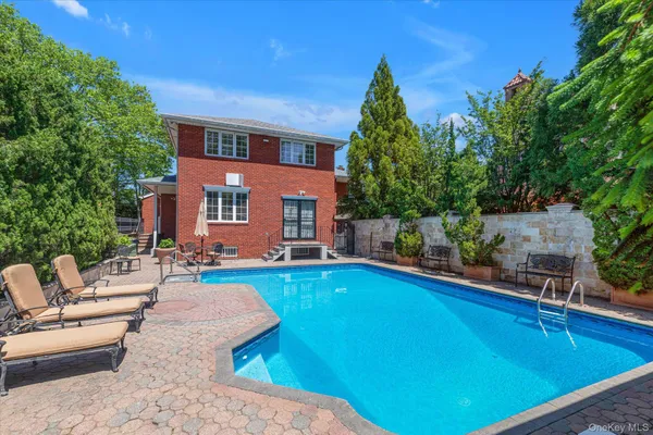 a swimming pool with outdoor seating and yard