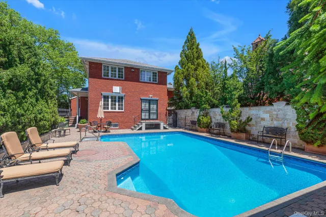 a swimming pool with outdoor seating and yard
