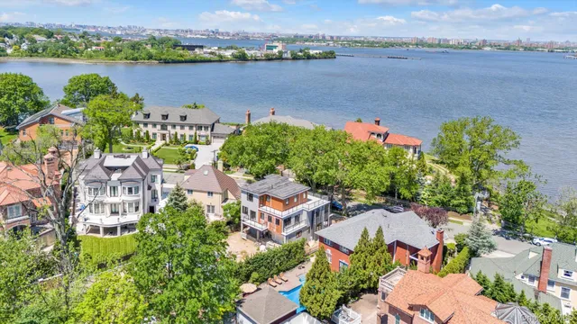 an aerial view of lake and residential houses with outdoor space and ocean view