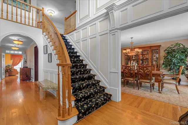 a view of entryway and hall with wooden floor