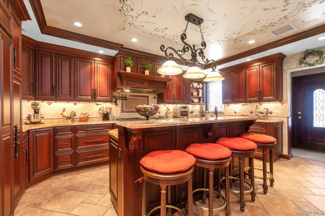 a kitchen with a dining table chairs sink and cabinets