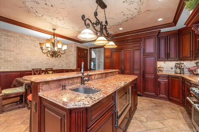 a kitchen with a sink a counter space cabinets and stainless steel appliances