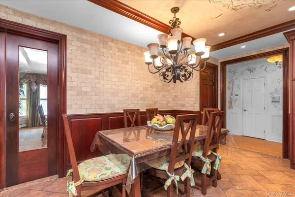 a view of a dining room with furniture and chandelier