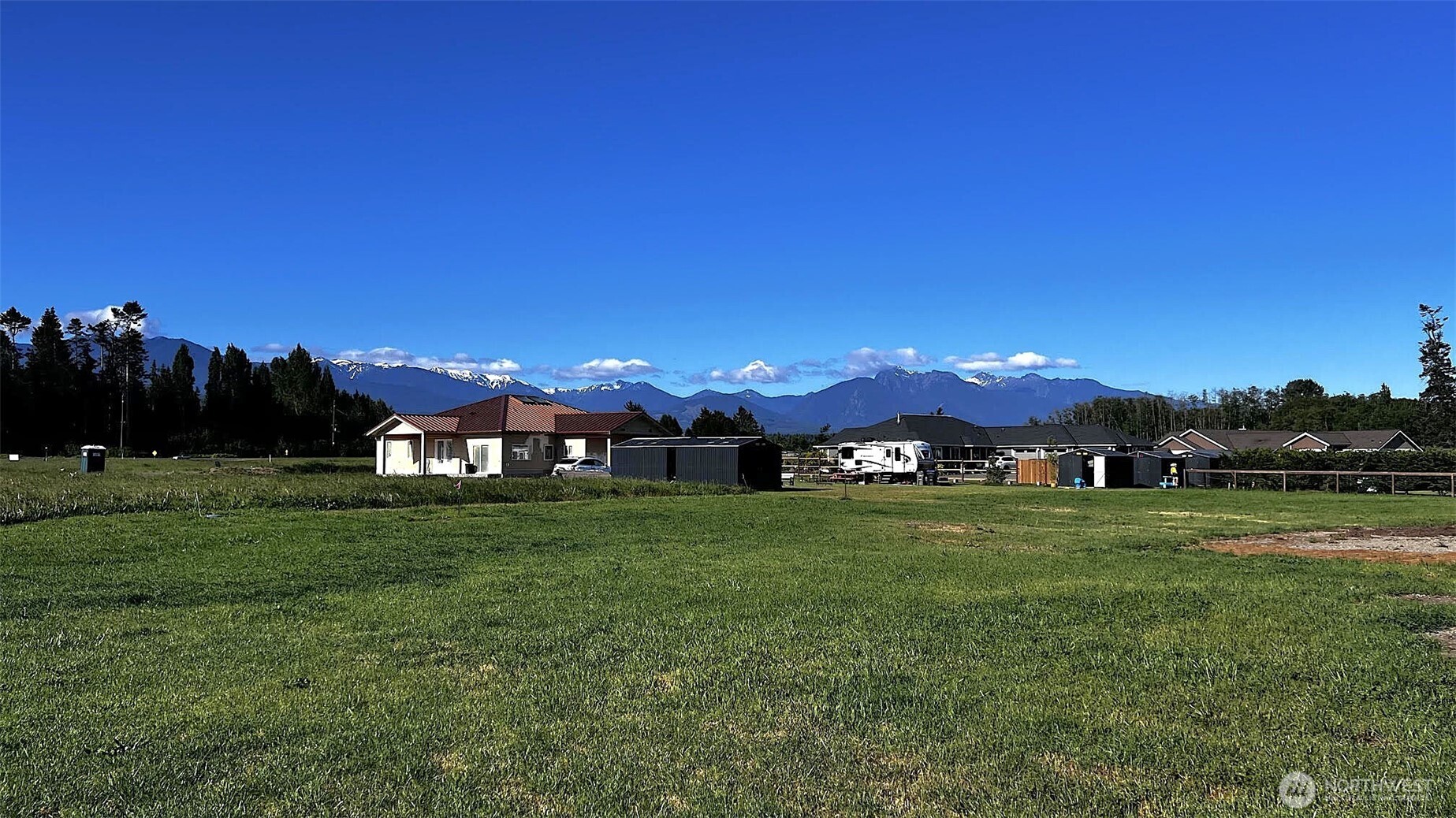 9999 Macleay Road Sequim, WA 98382 - Photo 10 of 16 a view of a big yard with a house in the background