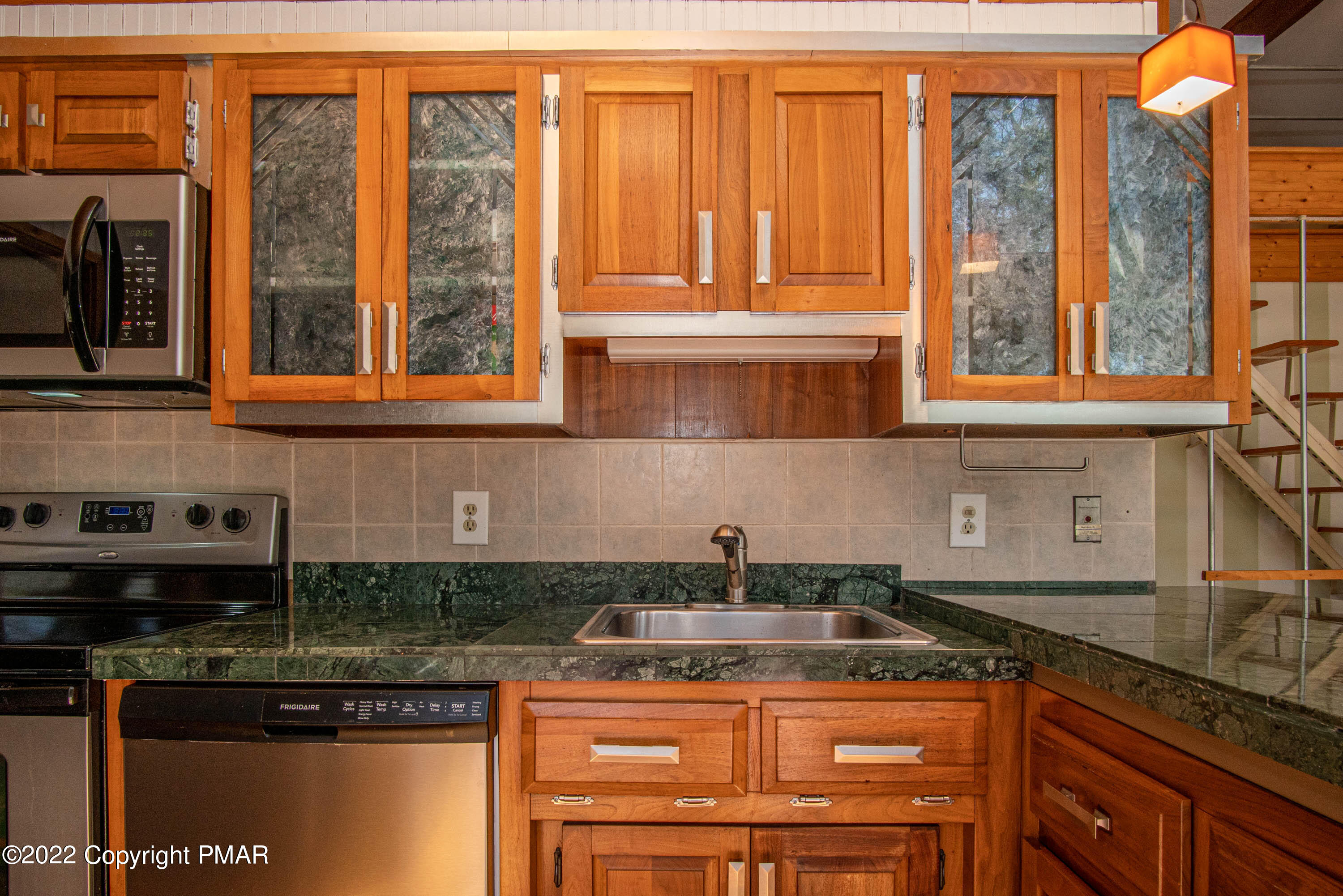 6374 Decker Road Bushkill, PA 18324 - Photo 12 of 60 a kitchen with stainless steel appliances granite countertop a sink a stove and a microwave
