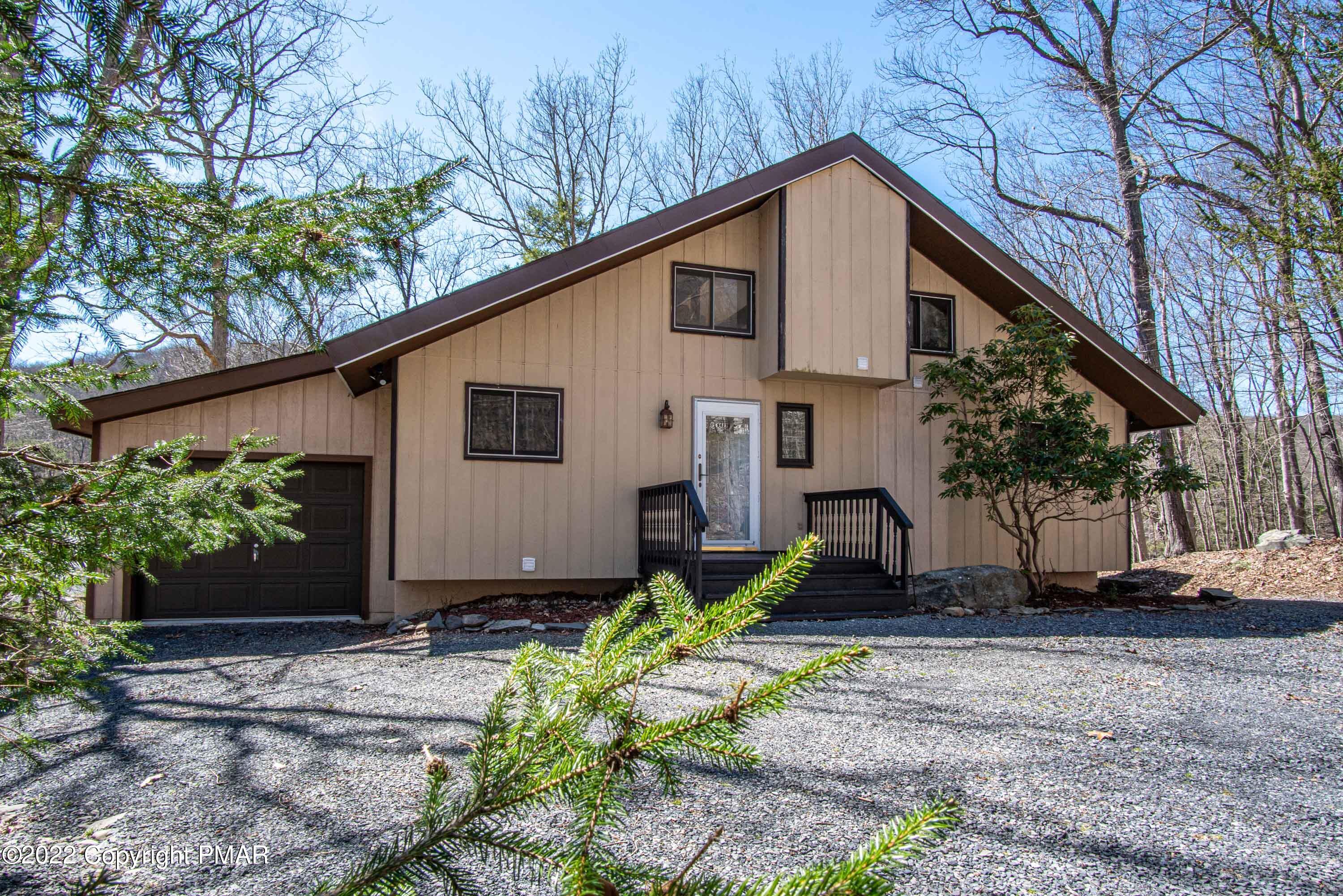 6374 Decker Road Bushkill, PA 18324 - Photo 2 of 60 a front view of a house with garden
