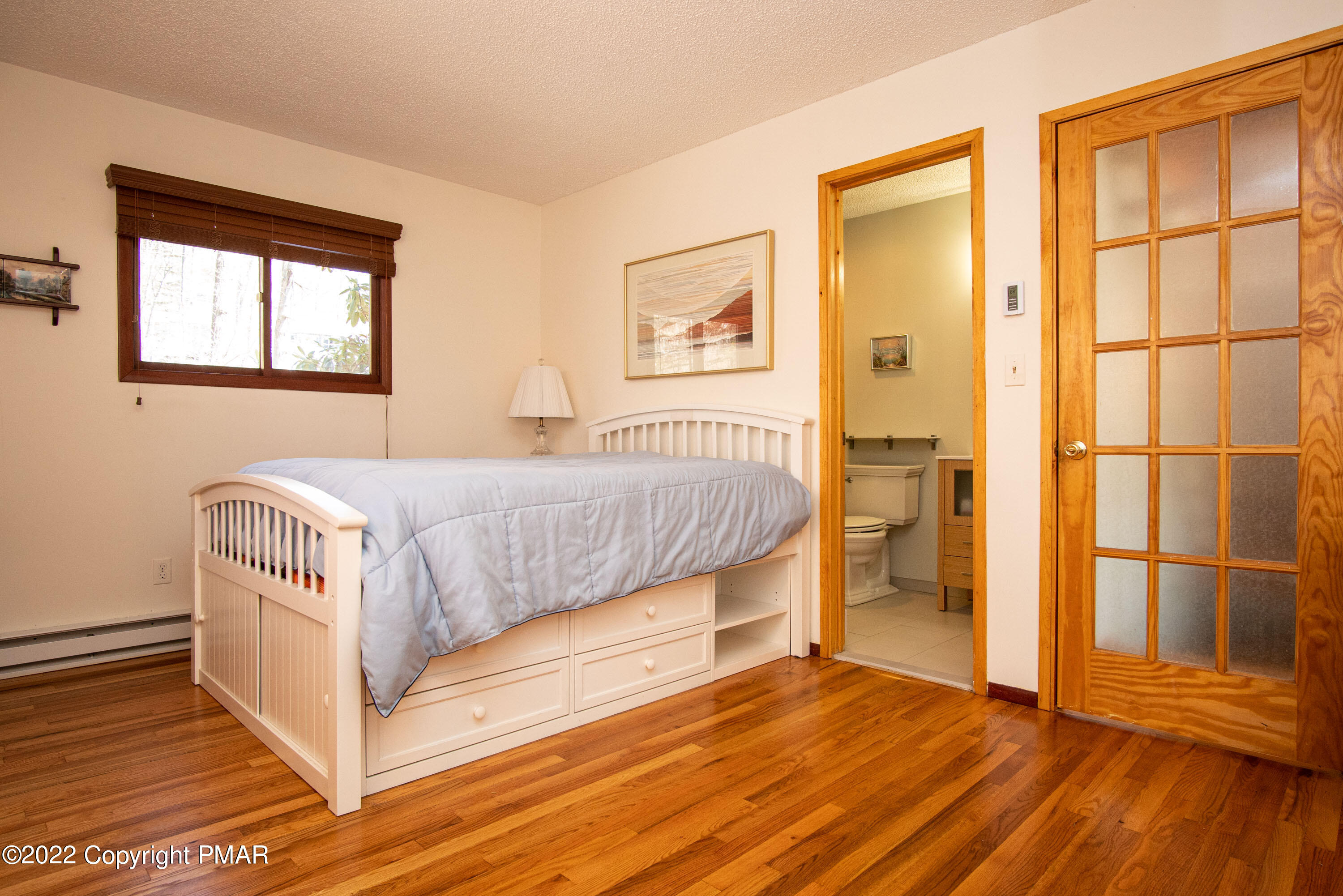 6374 Decker Road Bushkill, PA 18324 - Photo 25 of 60 a bedroom with a bed and wooden floor