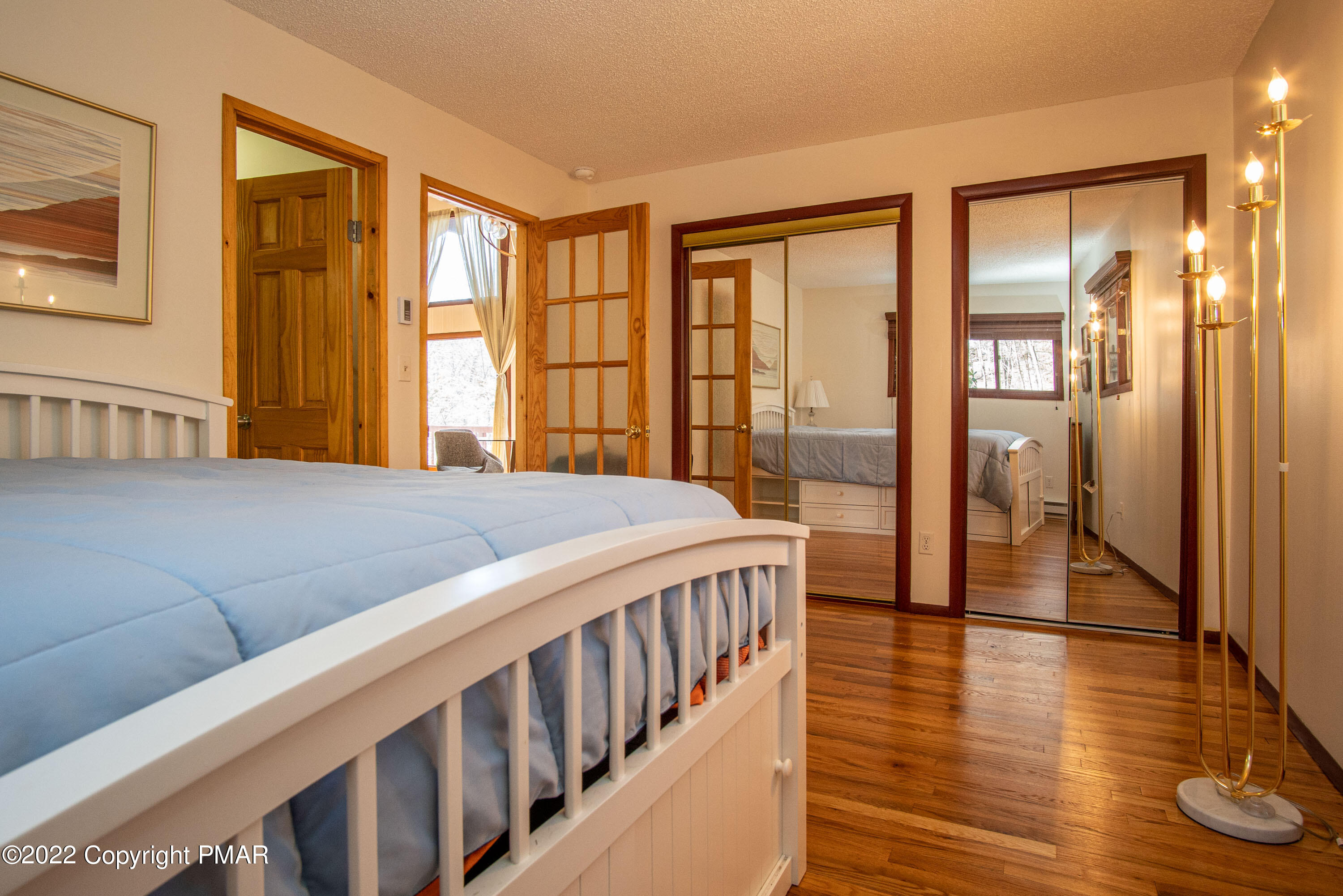 6374 Decker Road Bushkill, PA 18324 - Photo 27 of 60 a bedroom with a balcony a bed and a large window