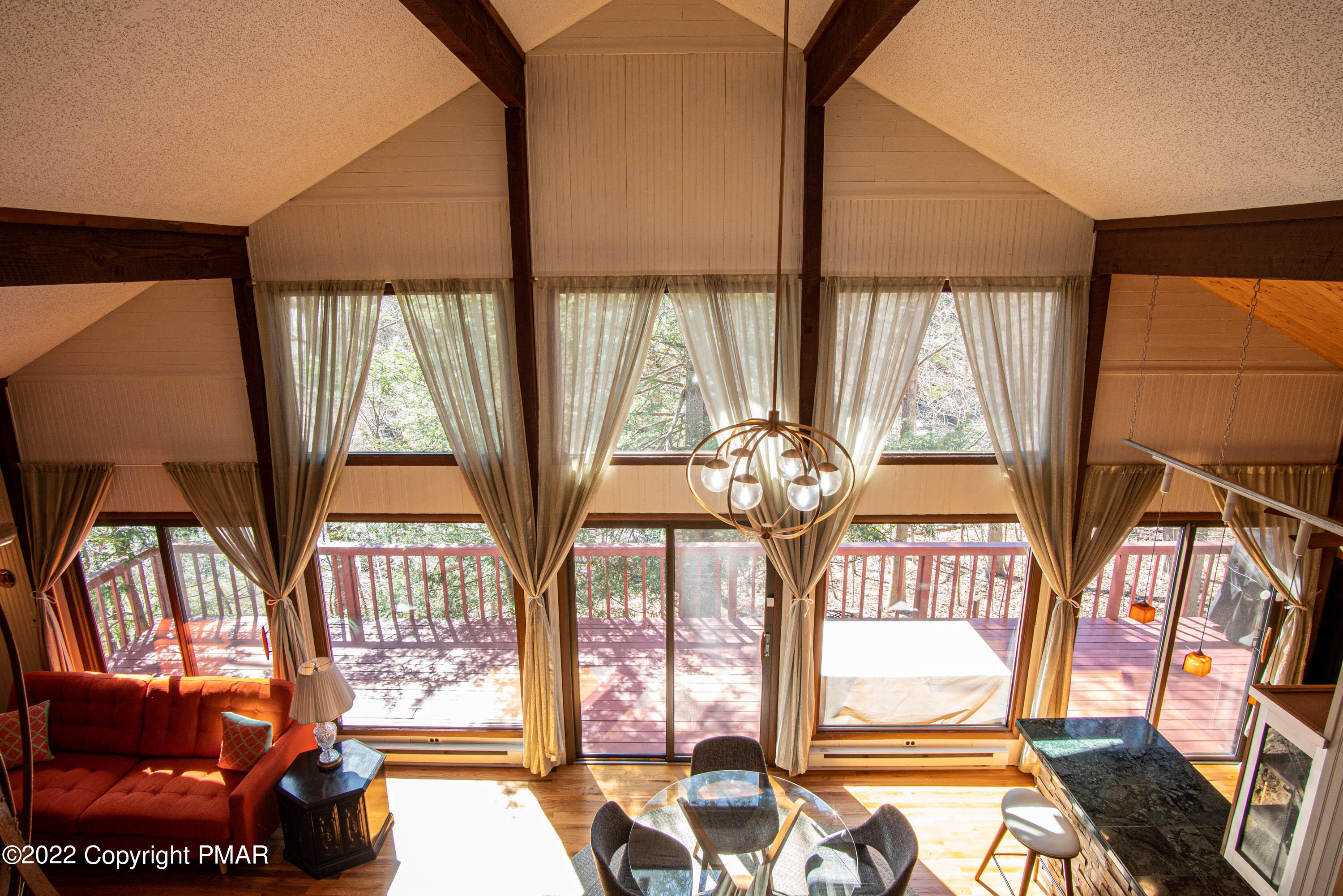 6374 Decker Road Bushkill, PA 18324 - Photo 32 of 60 a living room filled with furniture and floor to ceiling windows
