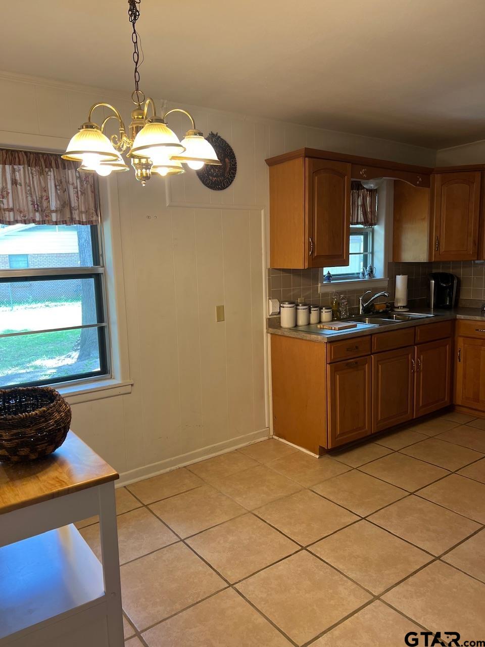 320 Bowers Street Lindale, TX 75771 - Photo 17 of 31 a kitchen with stainless steel appliances granite countertop a sink cabinets and window