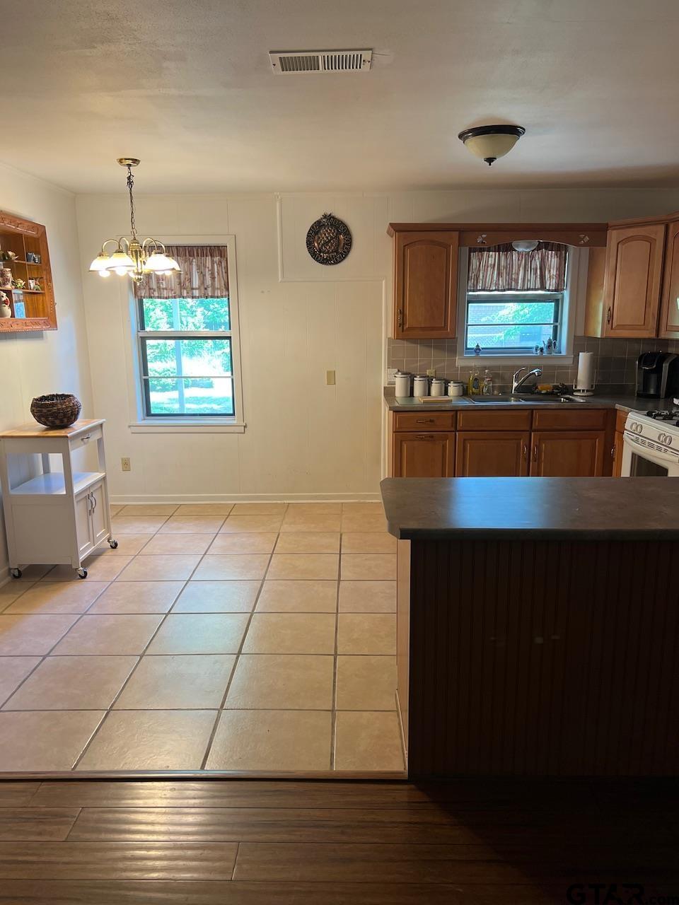 320 Bowers Street Lindale, TX 75771 - Photo 18 of 31 a kitchen with stainless steel appliances a sink and a stove