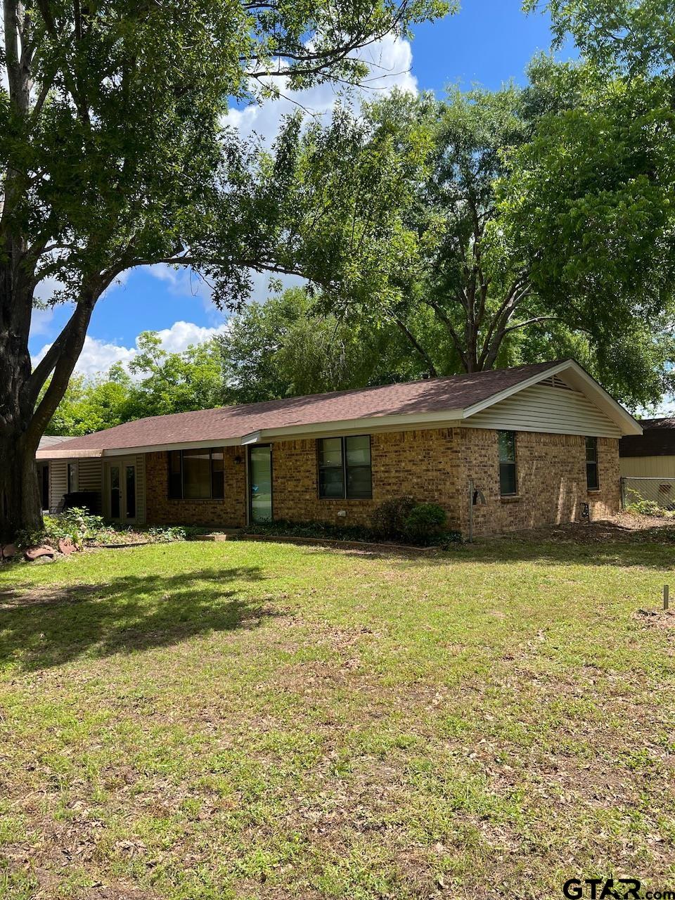 320 Bowers Street Lindale, TX 75771 - Photo 2 of 31 a front view of a house with a yard