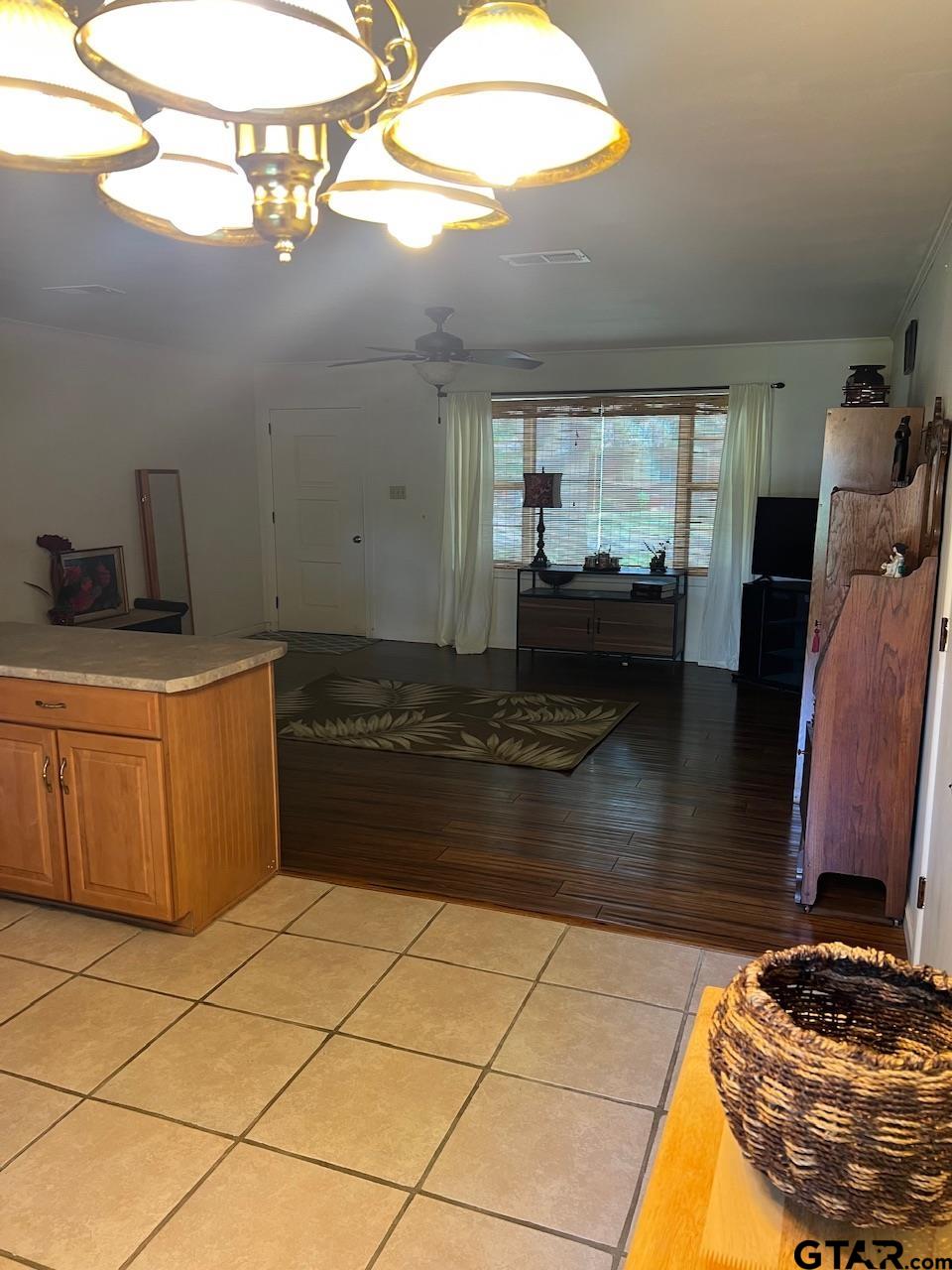 320 Bowers Street Lindale, TX 75771 - Photo 21 of 31 a kitchen with granite countertop a stove a sink and a microwave