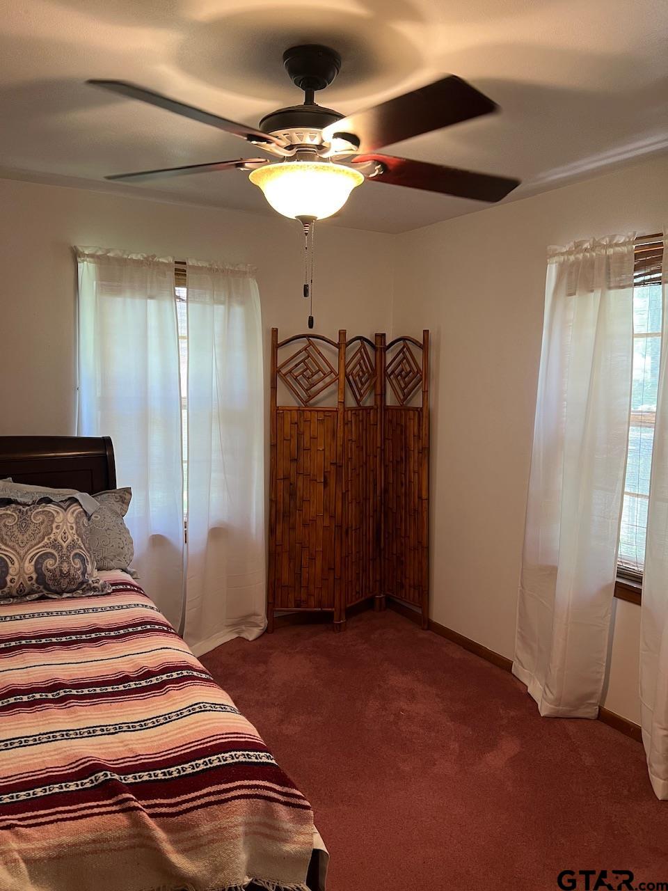 320 Bowers Street Lindale, TX 75771 - Photo 25 of 31 a bedroom with a bed and a chandelier