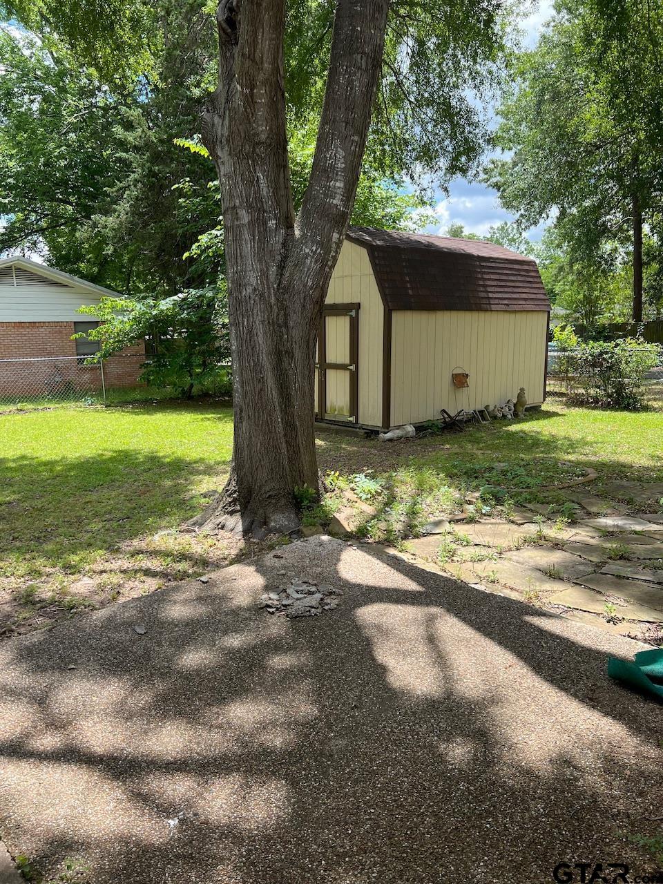 320 Bowers Street Lindale, TX 75771 - Photo 26 of 31 a view of a house with a yard and large tree
