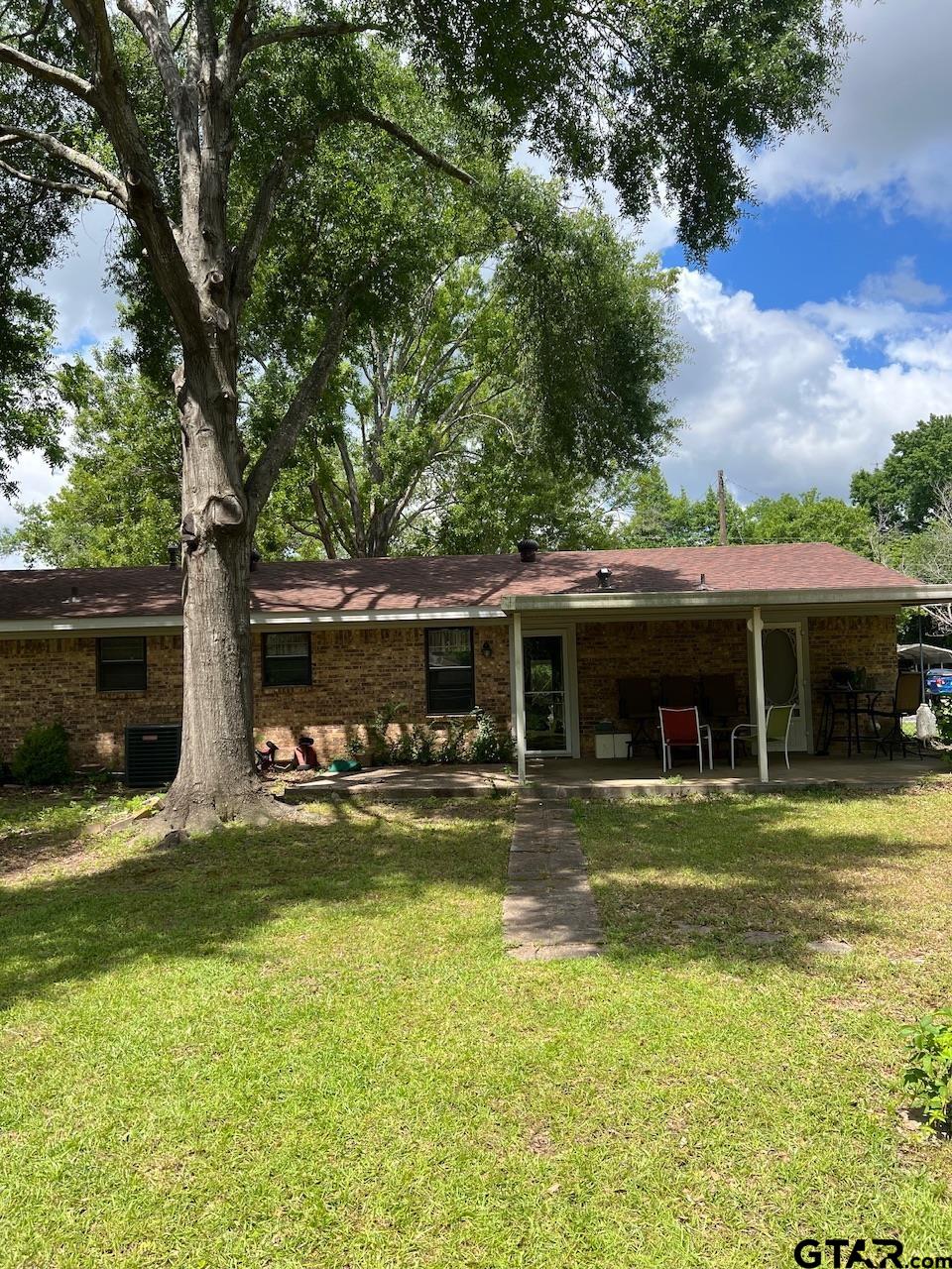 320 Bowers Street Lindale, TX 75771 - Photo 28 of 31 a view of a house with swimming pool next to a yard