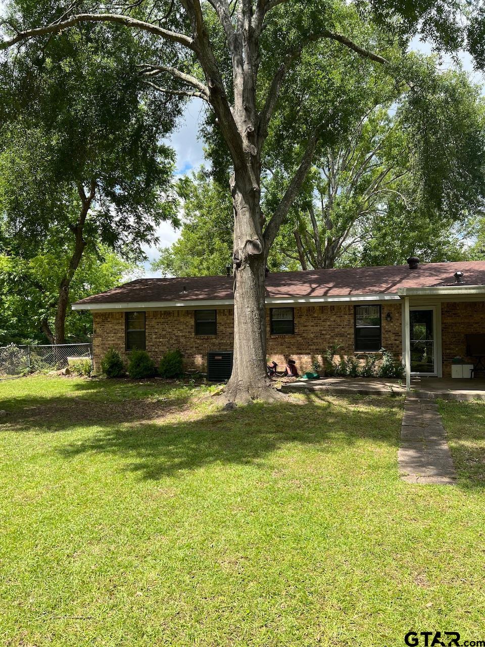 320 Bowers Street Lindale, TX 75771 - Photo 29 of 31 a front view of house with yard and green space
