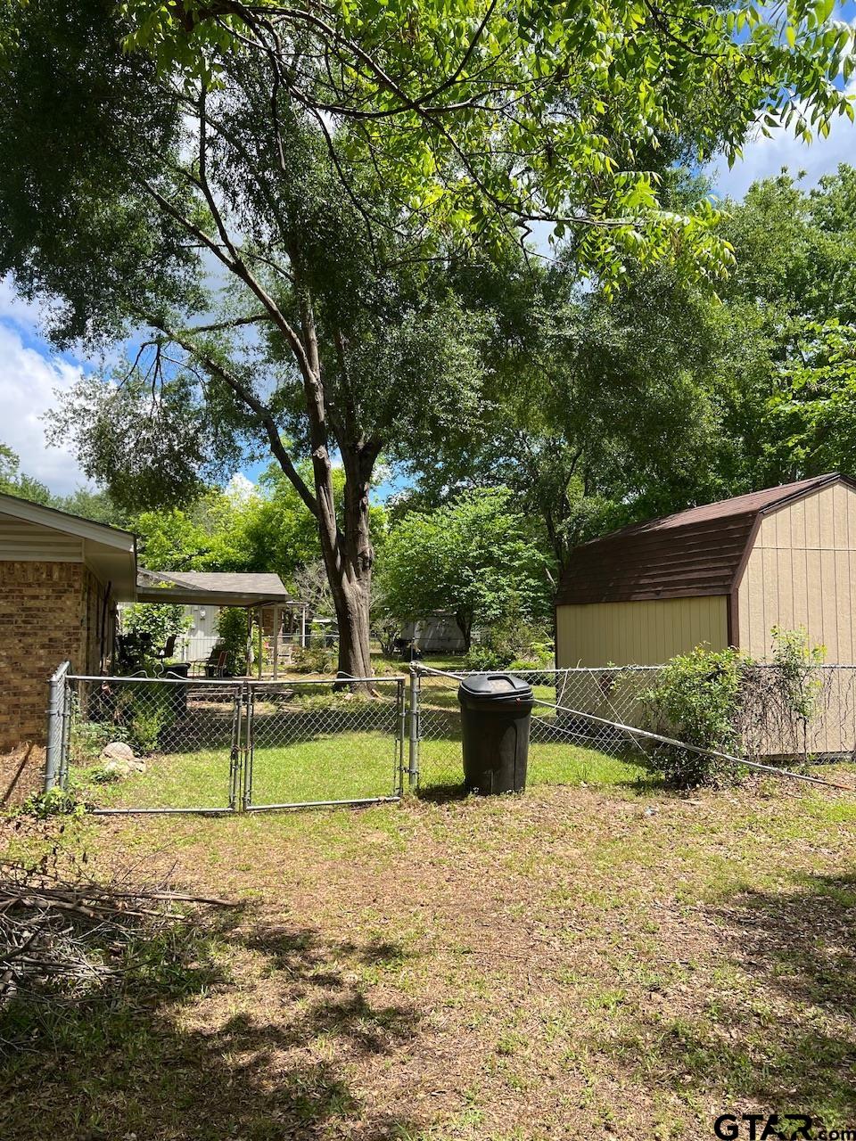 320 Bowers Street Lindale, TX 75771 - Photo 3 of 31 a backyard of a house with yard and outdoor seating