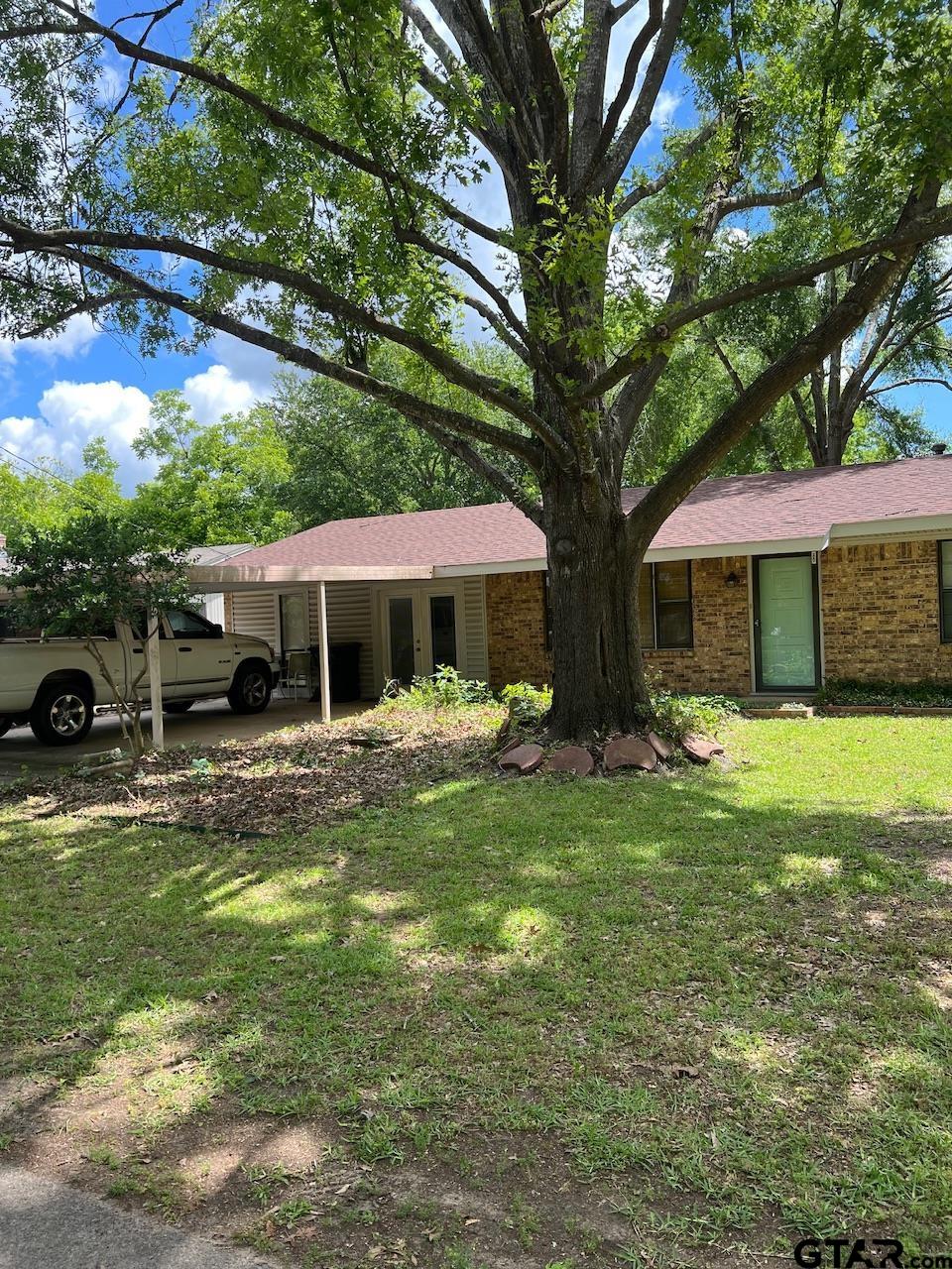 320 Bowers Street Lindale, TX 75771 - Photo 10 of 31 a front view of a house with swimming pool and porch