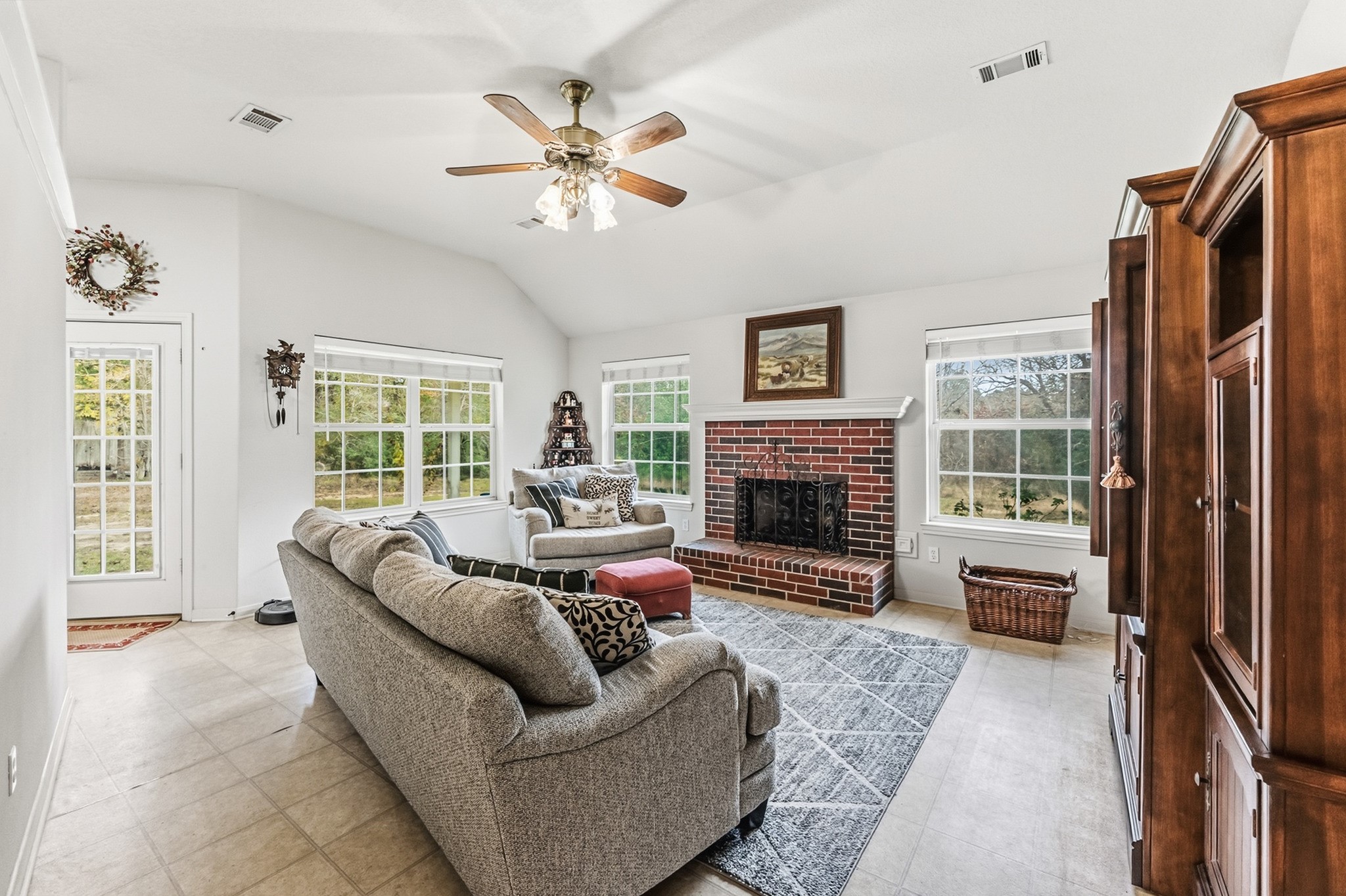 691 Bishop Road Huntsville, TX 77320 - Photo 5 of 32 a living room with furniture large window and a fireplace