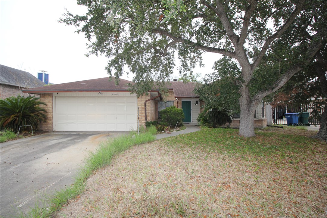 a front view of a house with a yard and a garage